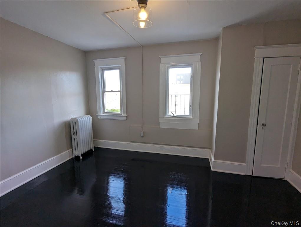 65 Academy Street, Unit 7 Poughkeepsie, NY 12601 - Photo 13 of 19 a view of empty room with wooden floor and fan