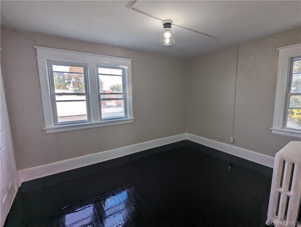 65 Academy Street, Unit 7 Poughkeepsie, NY 12601 - Photo 15 of 19 a view of an empty room with wooden floor and a window