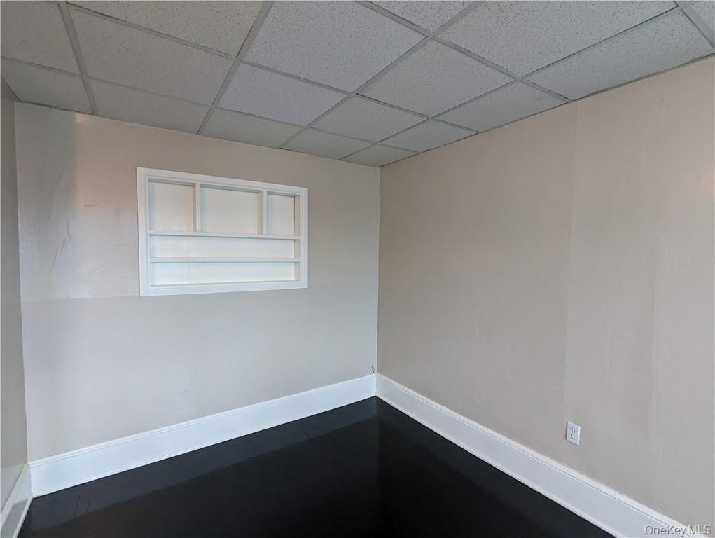 65 Academy Street, Unit 7 Poughkeepsie, NY 12601 - Photo 18 of 19 a view of an empty room with wooden floor