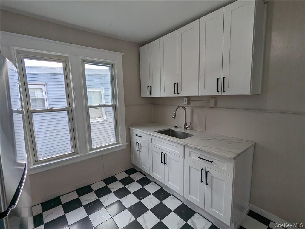 65 Academy Street, Unit 7 Poughkeepsie, NY 12601 - Photo 3 of 19 a kitchen with a sink a stove and cabinets