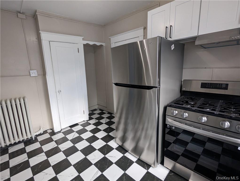 65 Academy Street, Unit 7 Poughkeepsie, NY 12601 - Photo 4 of 19 a kitchen with a refrigerator and a stove