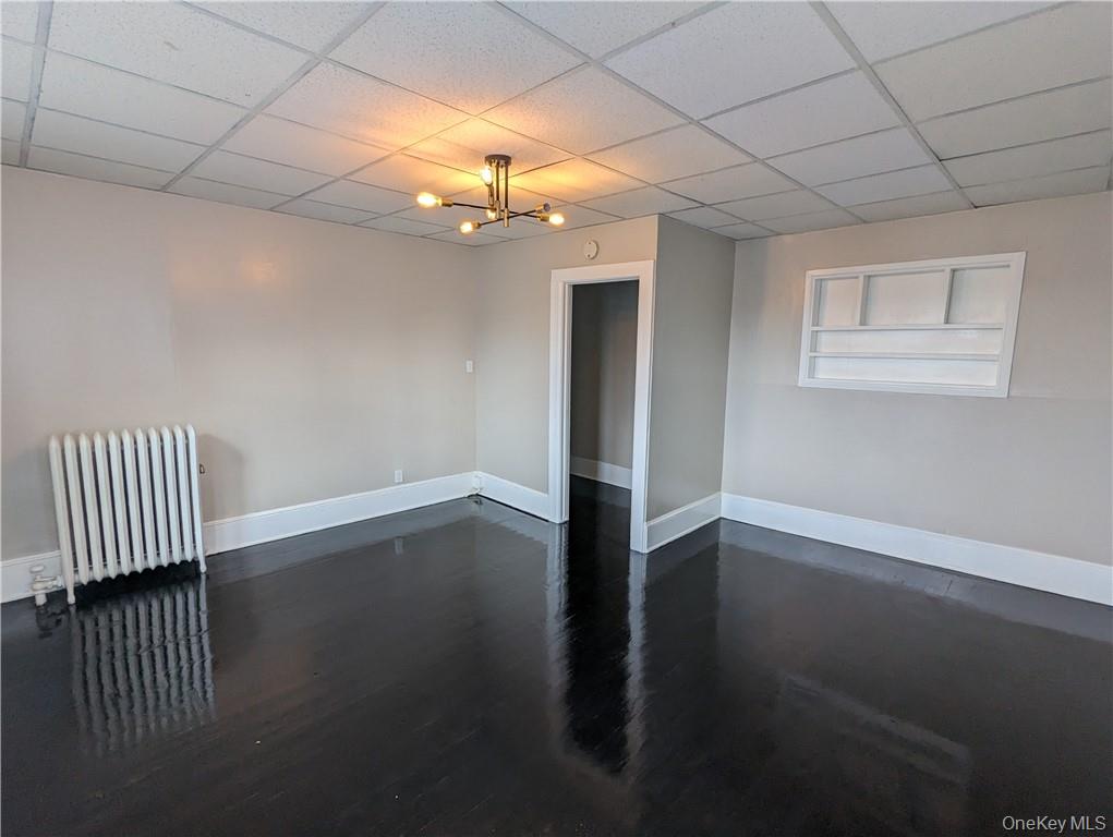 65 Academy Street, Unit 7 Poughkeepsie, NY 12601 - Photo 6 of 19 wooden floor in an empty room with a window