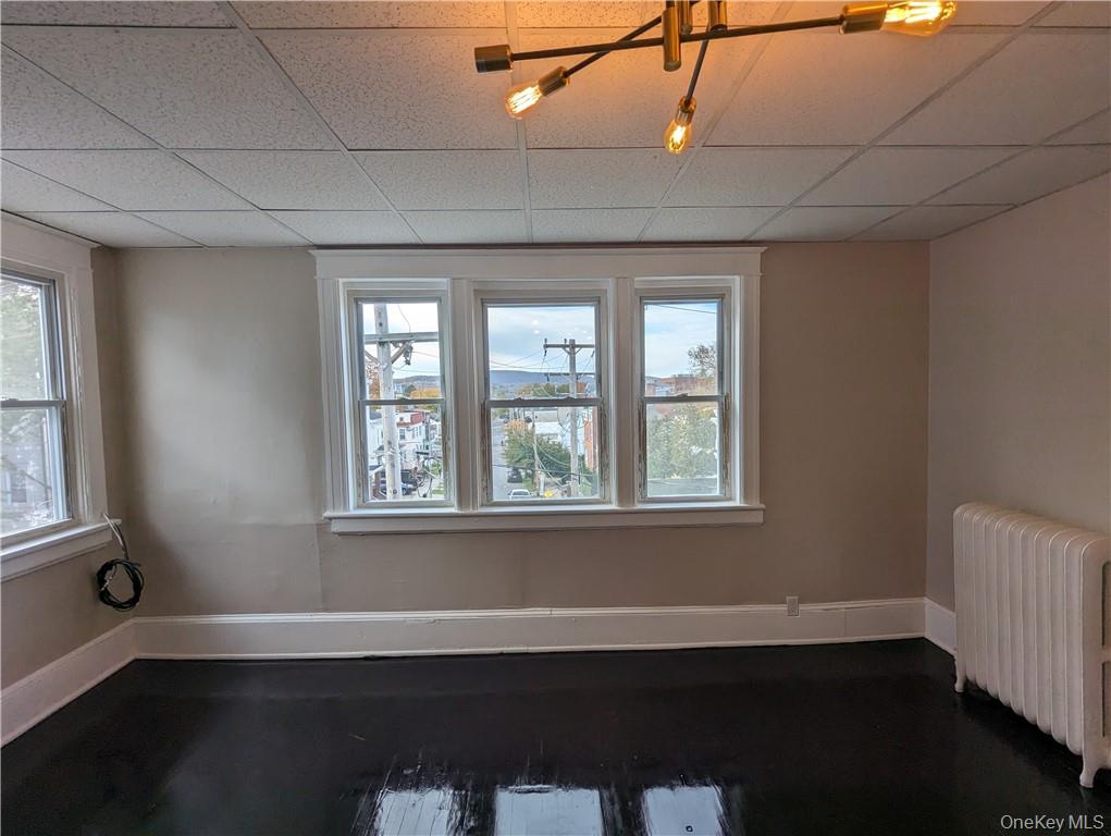 65 Academy Street, Unit 7 Poughkeepsie, NY 12601 - Photo 7 of 19 a view of an empty room with wooden floor and a window