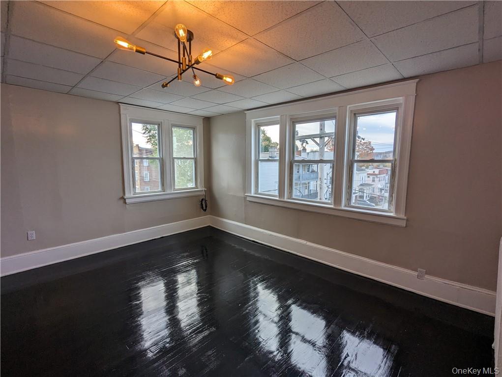 65 Academy Street, Unit 7 Poughkeepsie, NY 12601 - Photo 8 of 19 a view of an empty room with wooden floor and a window