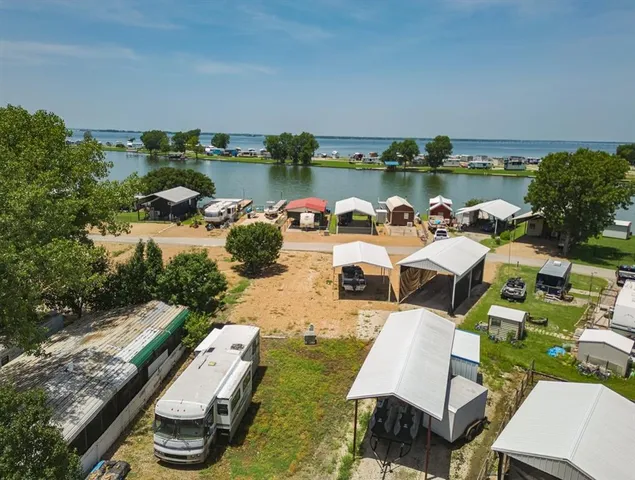 an aerial view of a house with outdoor space lake view and sitting space