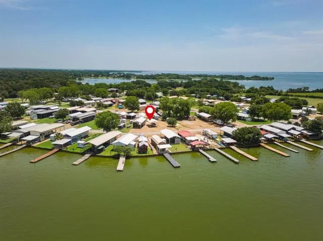 an aerial view of residential houses with outdoor space and swimming pool
