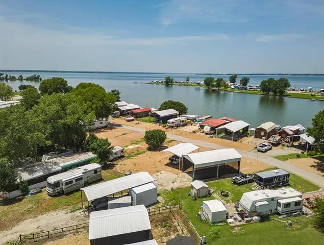 an aerial view of a house with a garden and lake view