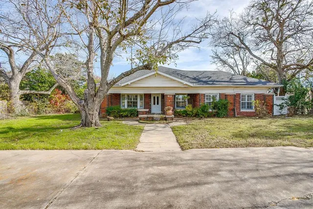 a front view of house with yard and green space