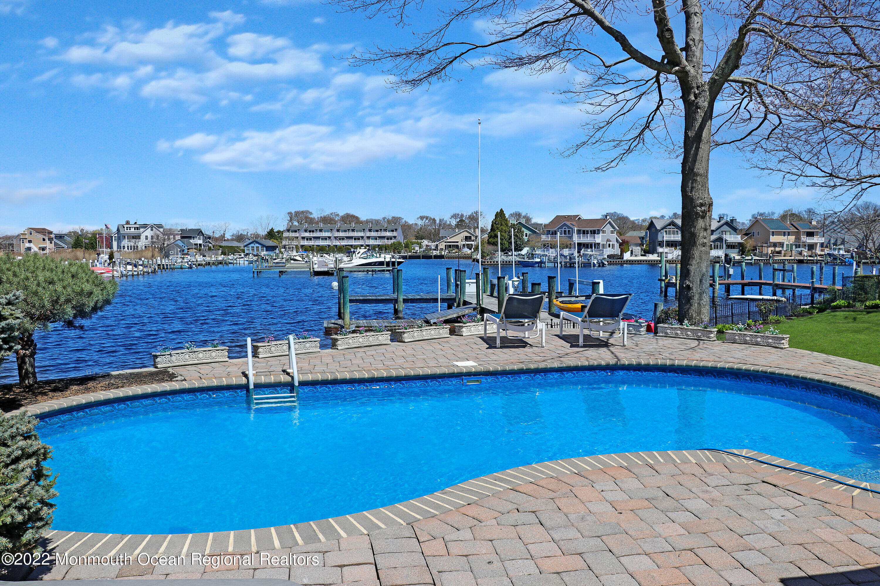 574 Harbor Road Brick, NJ 08724 - Photo 13 of 65 a view of a swimming pool and lounge chairs