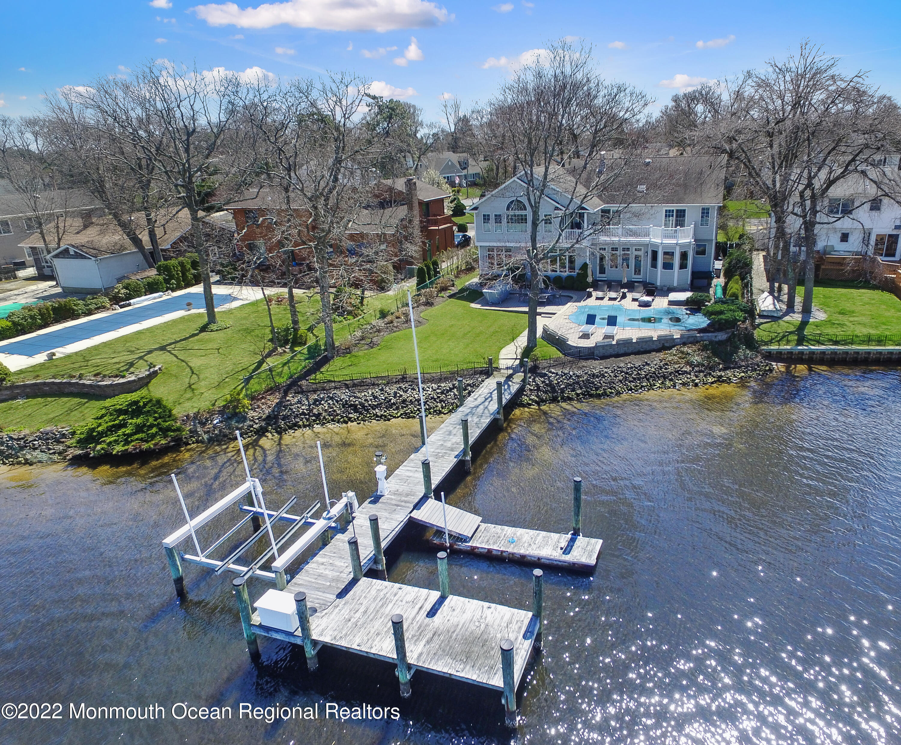 574 Harbor Road Brick, NJ 08724 - Photo 16 of 65 a view of a swimming pool with a patio and a yard