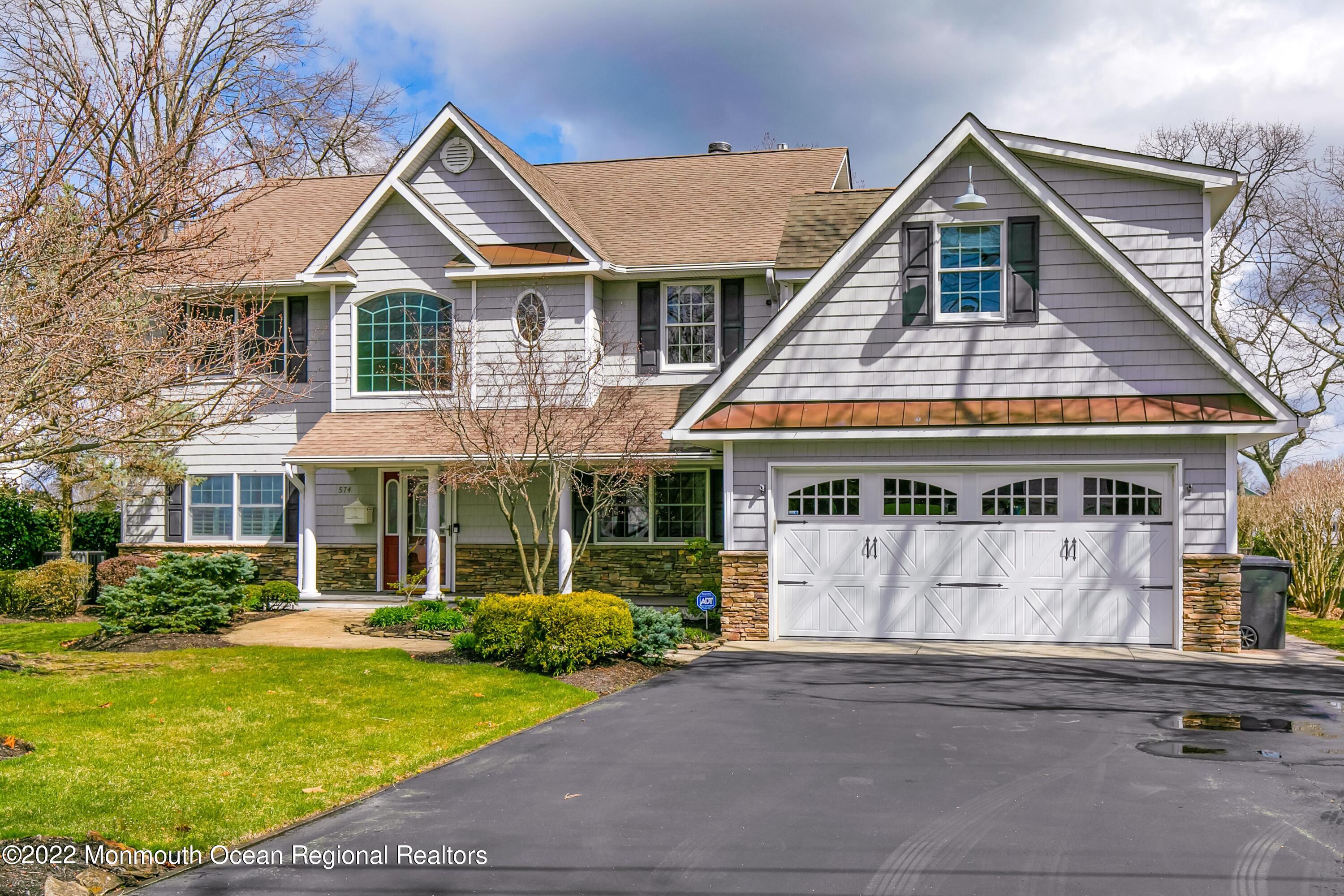 574 Harbor Road Brick, NJ 08724 - Photo 17 of 65 a front view of a house with a yard