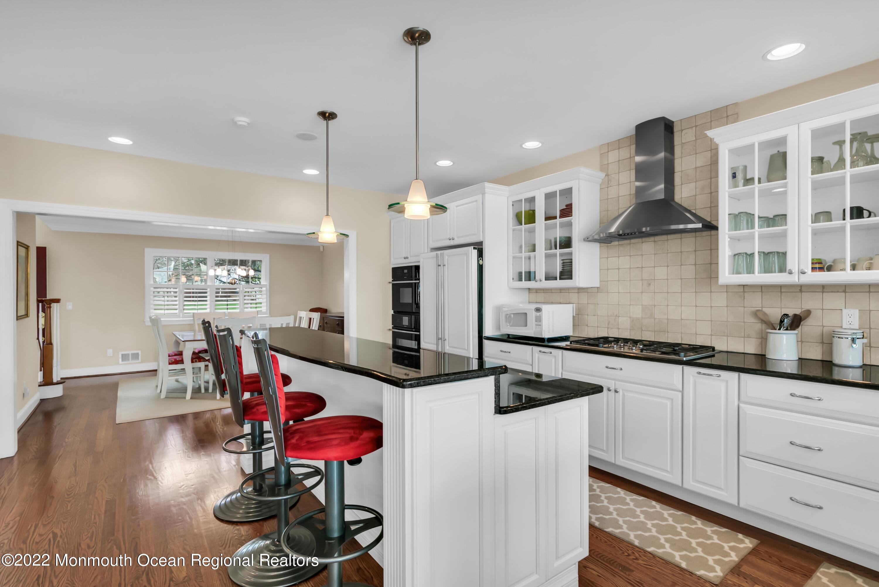 574 Harbor Road Brick, NJ 08724 - Photo 24 of 65 a kitchen with stainless steel appliances granite countertop a stove a sink and a refrigerator