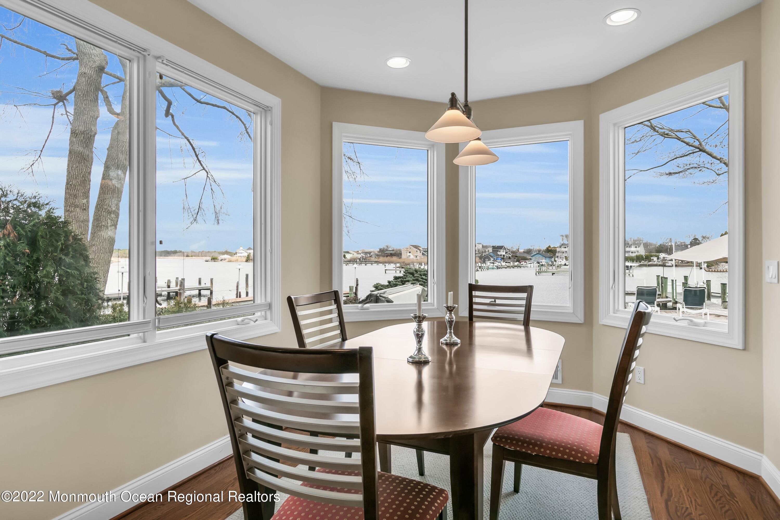 574 Harbor Road Brick, NJ 08724 - Photo 25 of 65 a dining room with furniture a chandelier and wooden floor