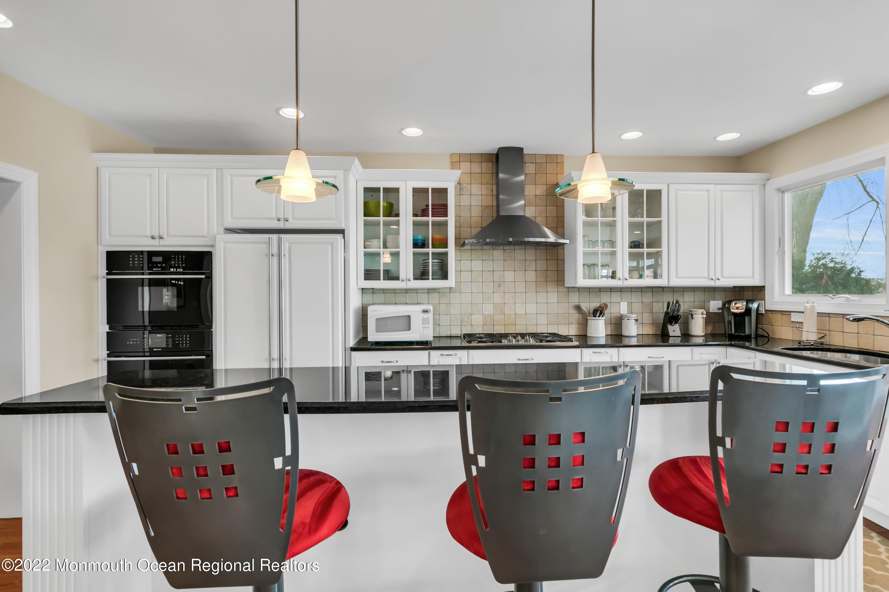 574 Harbor Road Brick, NJ 08724 - Photo 28 of 65 a kitchen with stainless steel appliances granite countertop a sink a stove a refrigerator and white cabinets