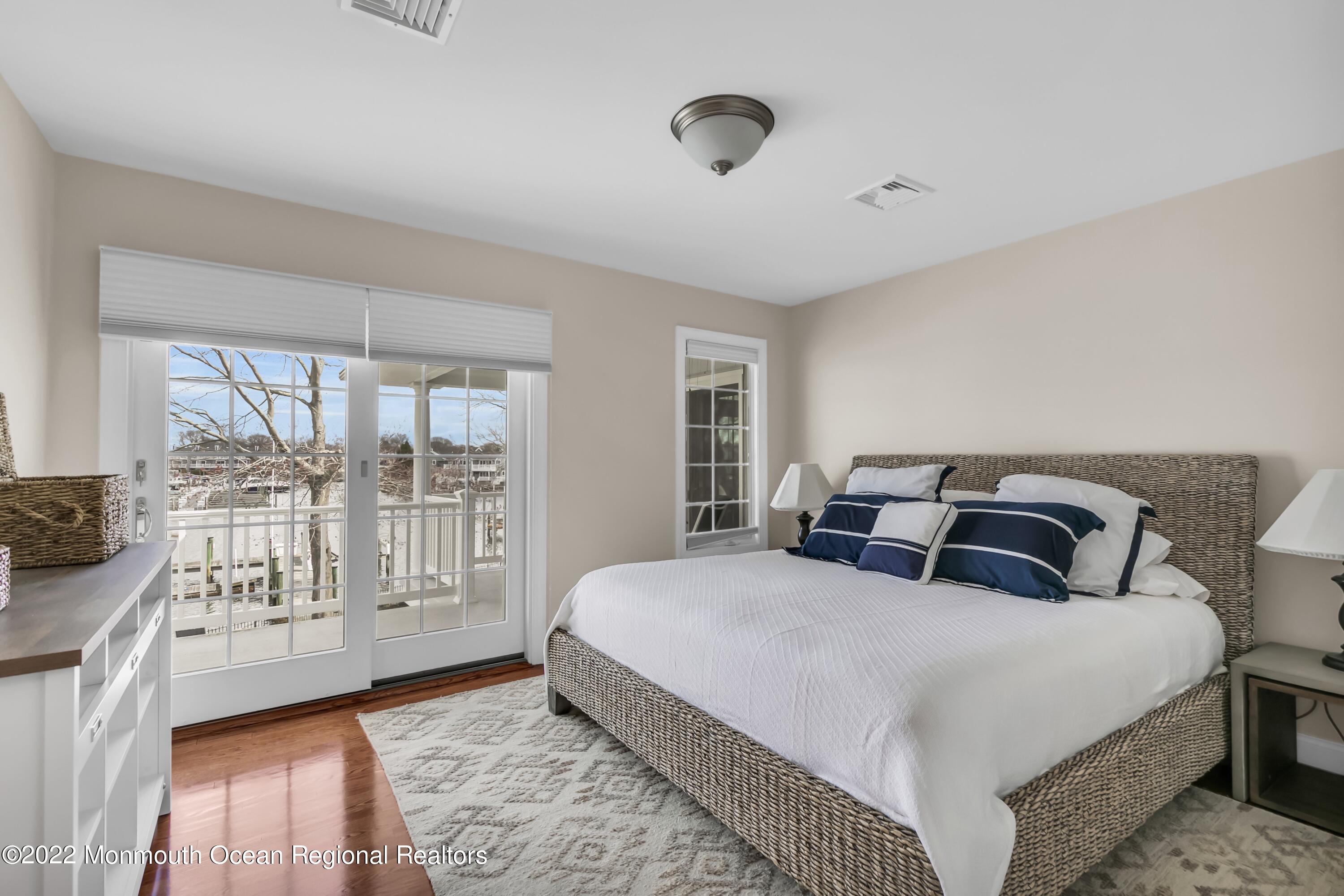 574 Harbor Road Brick, NJ 08724 - Photo 47 of 65 a bedroom with a balcony a bed and a table