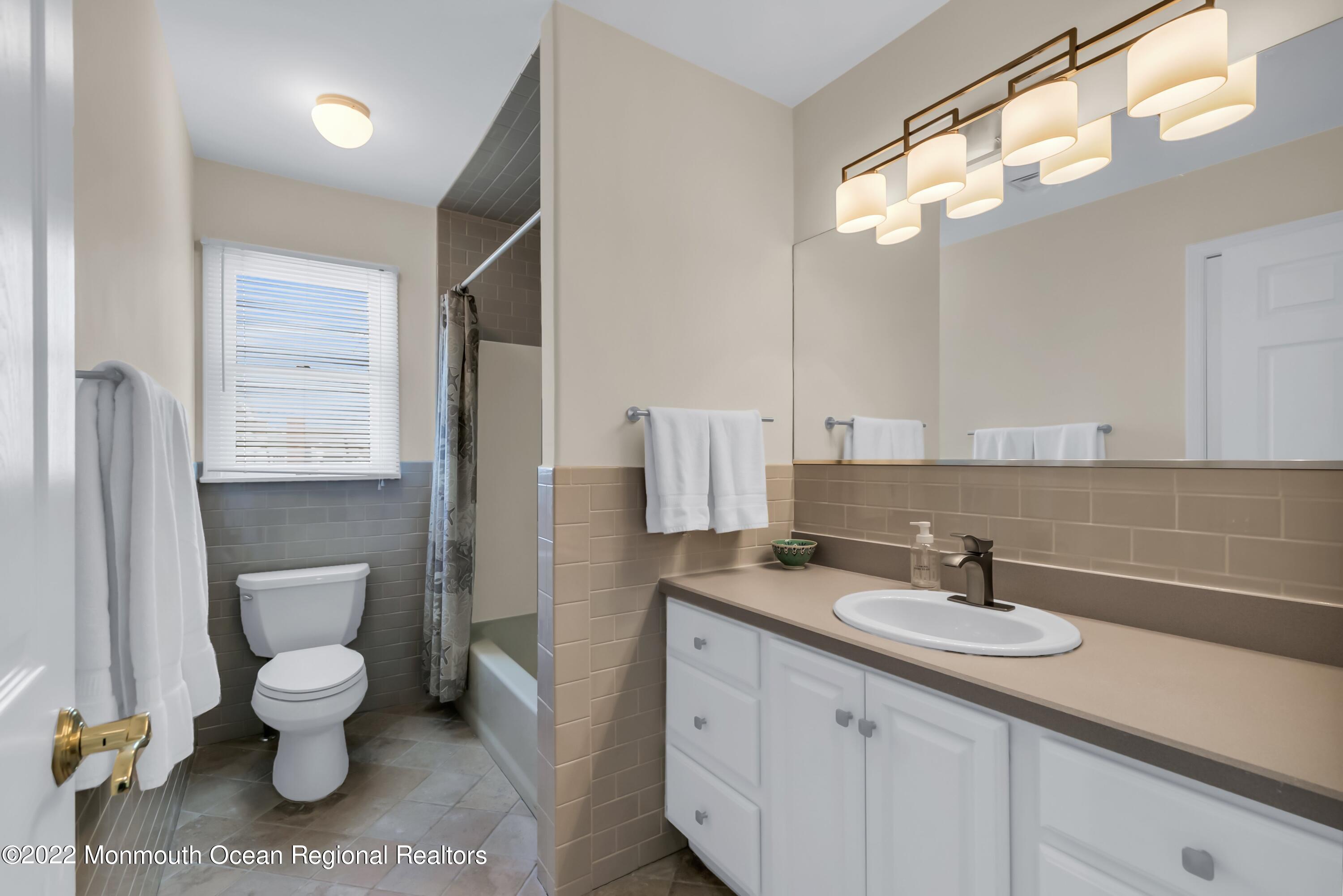 574 Harbor Road Brick, NJ 08724 - Photo 52 of 65 a bathroom with a toilet sink and mirror