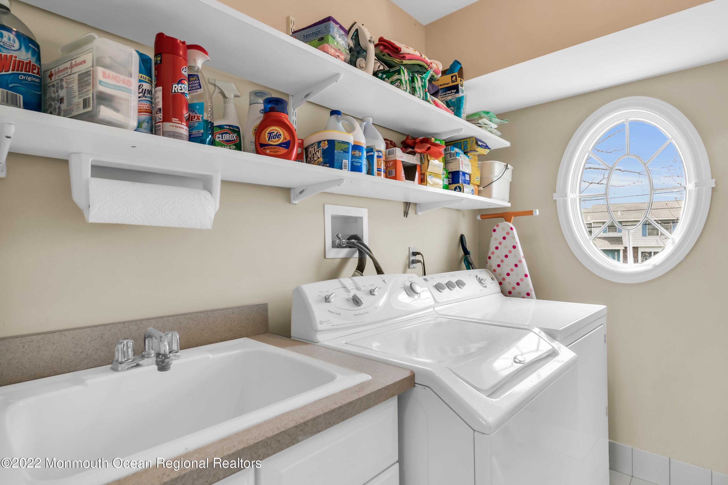 574 Harbor Road Brick, NJ 08724 - Photo 54 of 65 a bathroom with a sink a mirror and a window