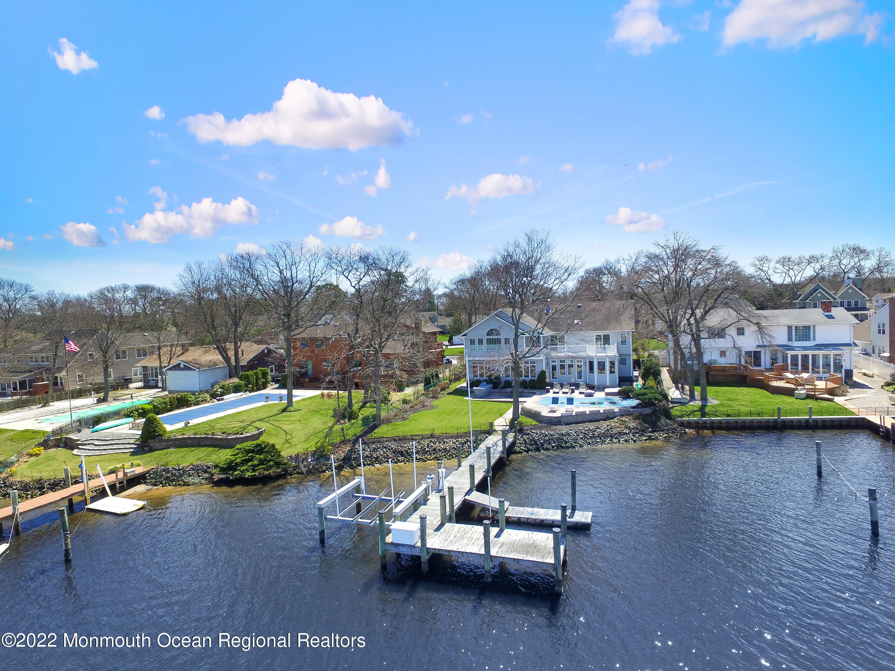 574 Harbor Road Brick, NJ 08724 - Photo 64 of 65 a view of a swimming pool with a bench and lawn chairs