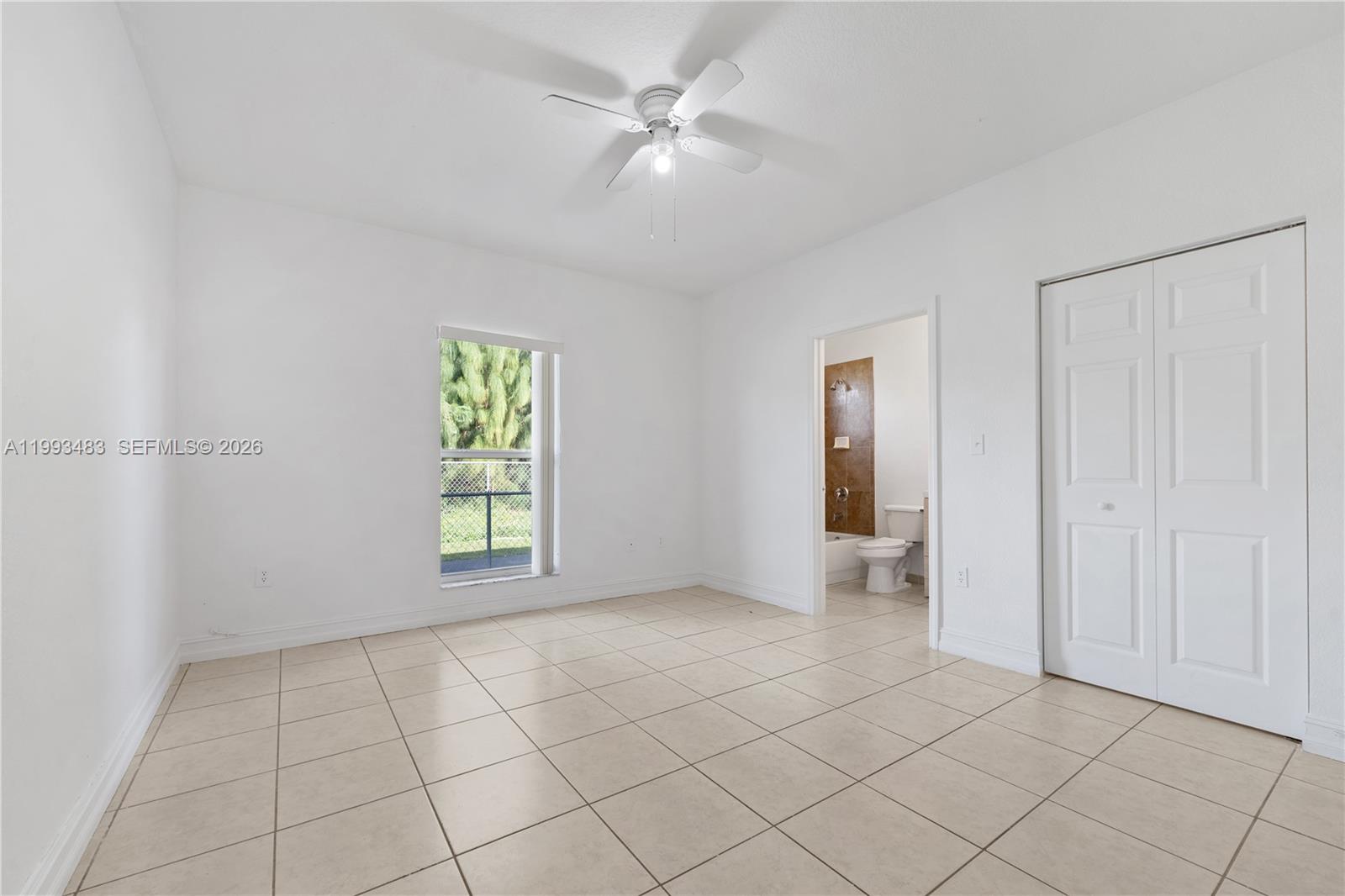 10357 Southwest 178th Street, Unit 10357 Miami, FL 33157 - Photo 19 of 25 an empty room with windows and fan