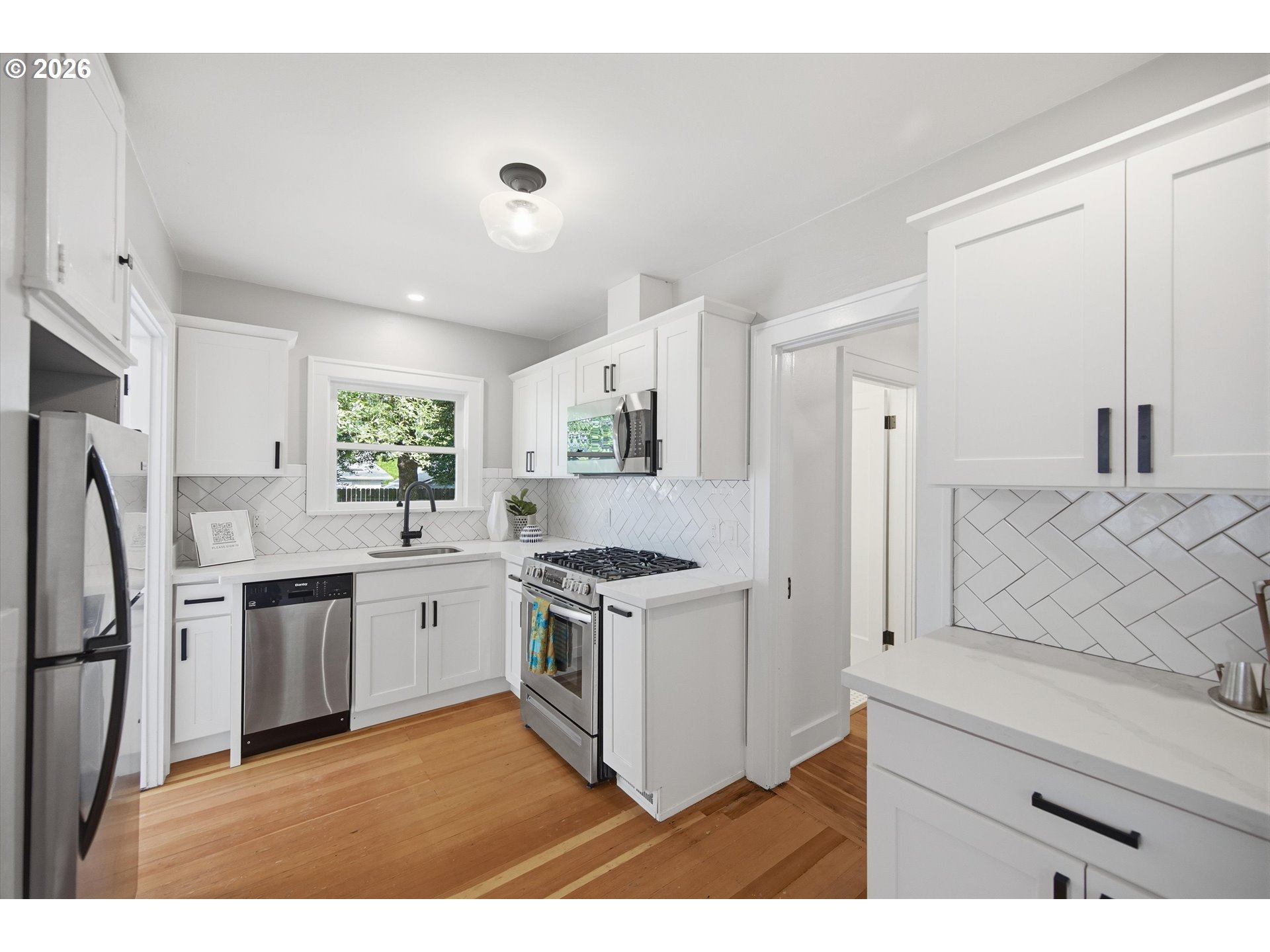 1934 Northeast 55th Avenue Portland, OR 97213 - Photo 12 of 23 a kitchen with stainless steel appliances granite countertop a stove a refrigerator and a sink