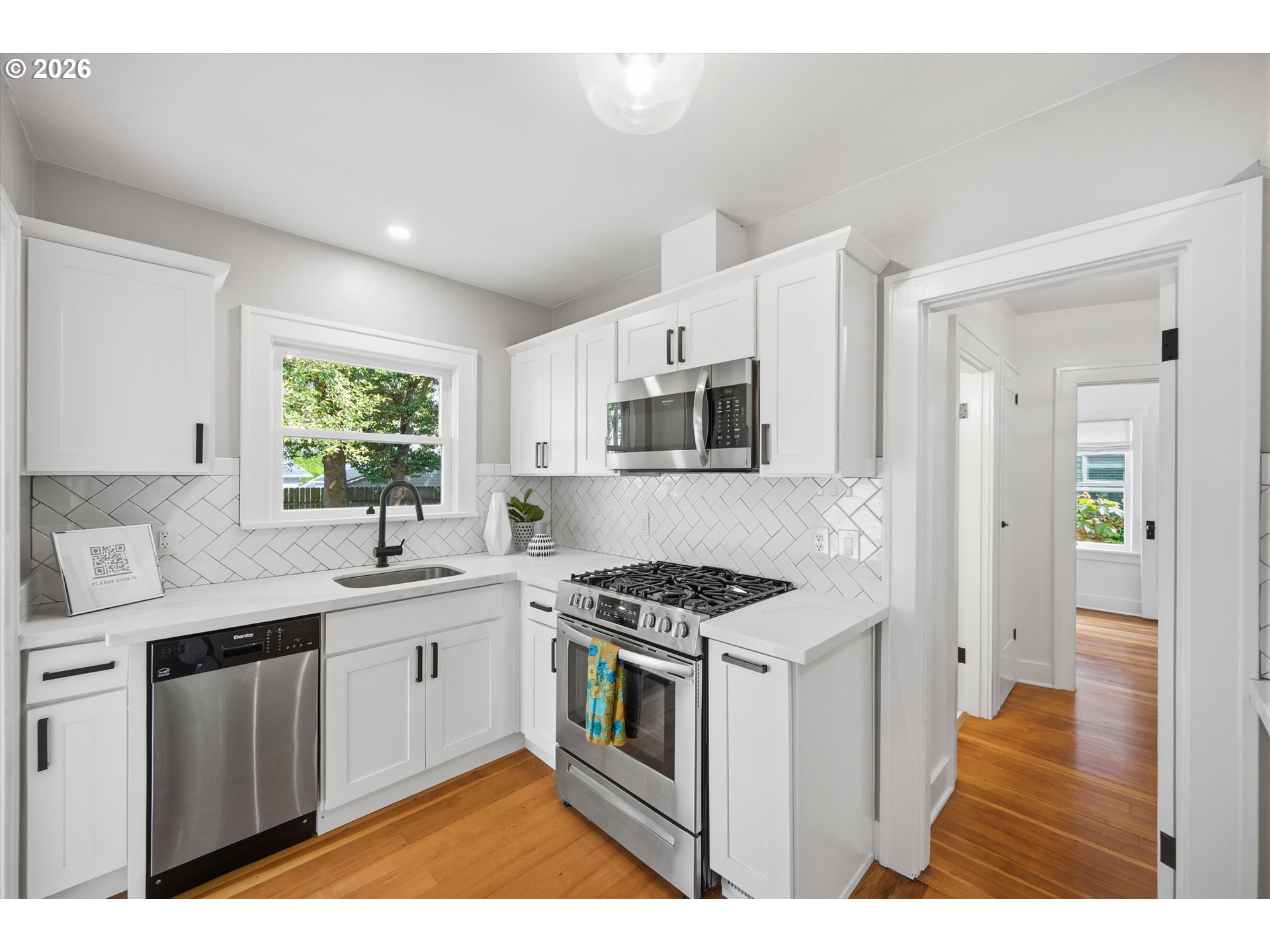 1934 Northeast 55th Avenue Portland, OR 97213 - Photo 17 of 23 a kitchen with stainless steel appliances kitchen island a white cabinets and wooden floor