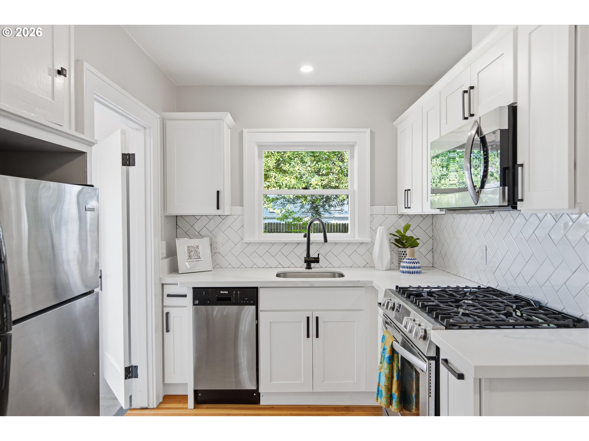 1934 Northeast 55th Avenue Portland, OR 97213 - Photo 20 of 23 a kitchen with stainless steel appliances a sink stove and refrigerator