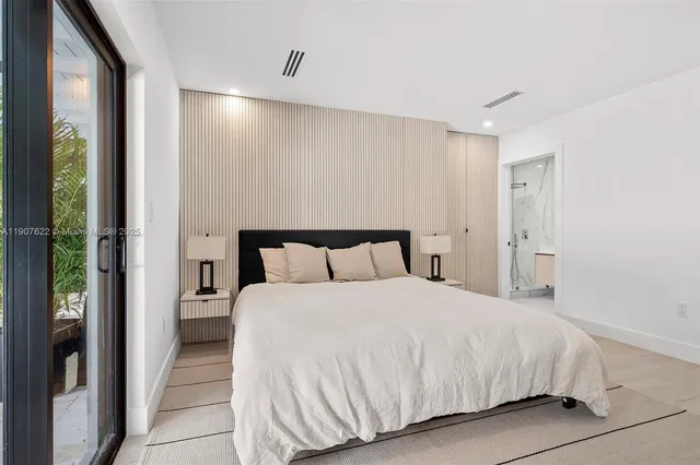 an empty room with windows and ceiling fan