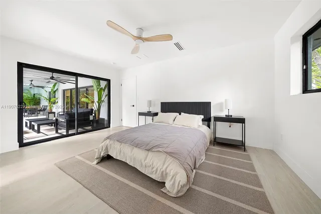 a living room with patio furniture and a garden