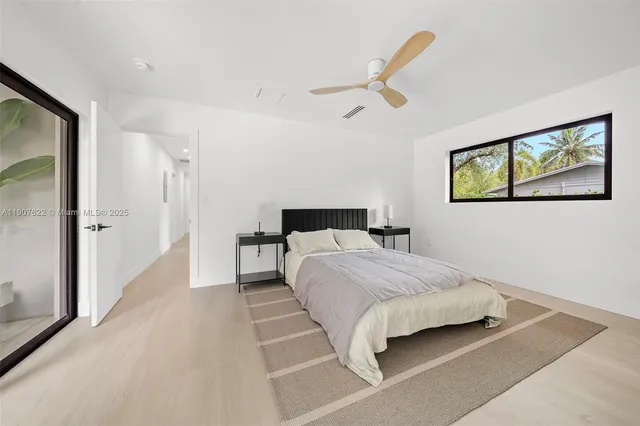 a view of a patio with a table and chairs and potted plants