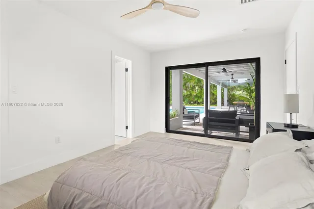 a view of a house with backyard swimming pool and sitting area