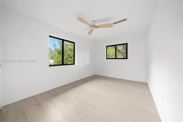 a front view of a house with yard and green space