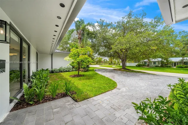 a living room with furniture and large window