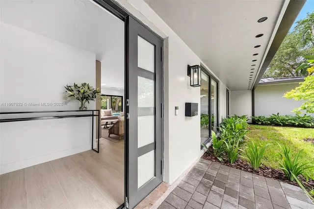 a living room with furniture and large windows
