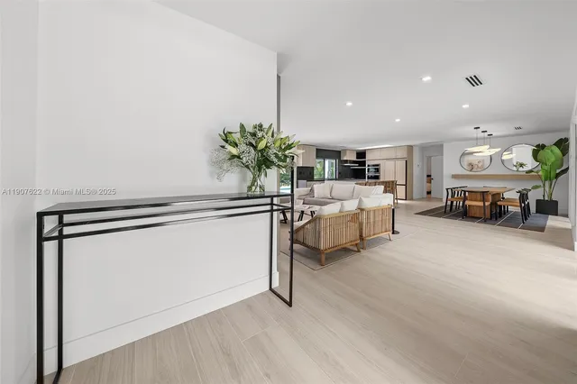 a dining room with furniture a chandelier and a rug
