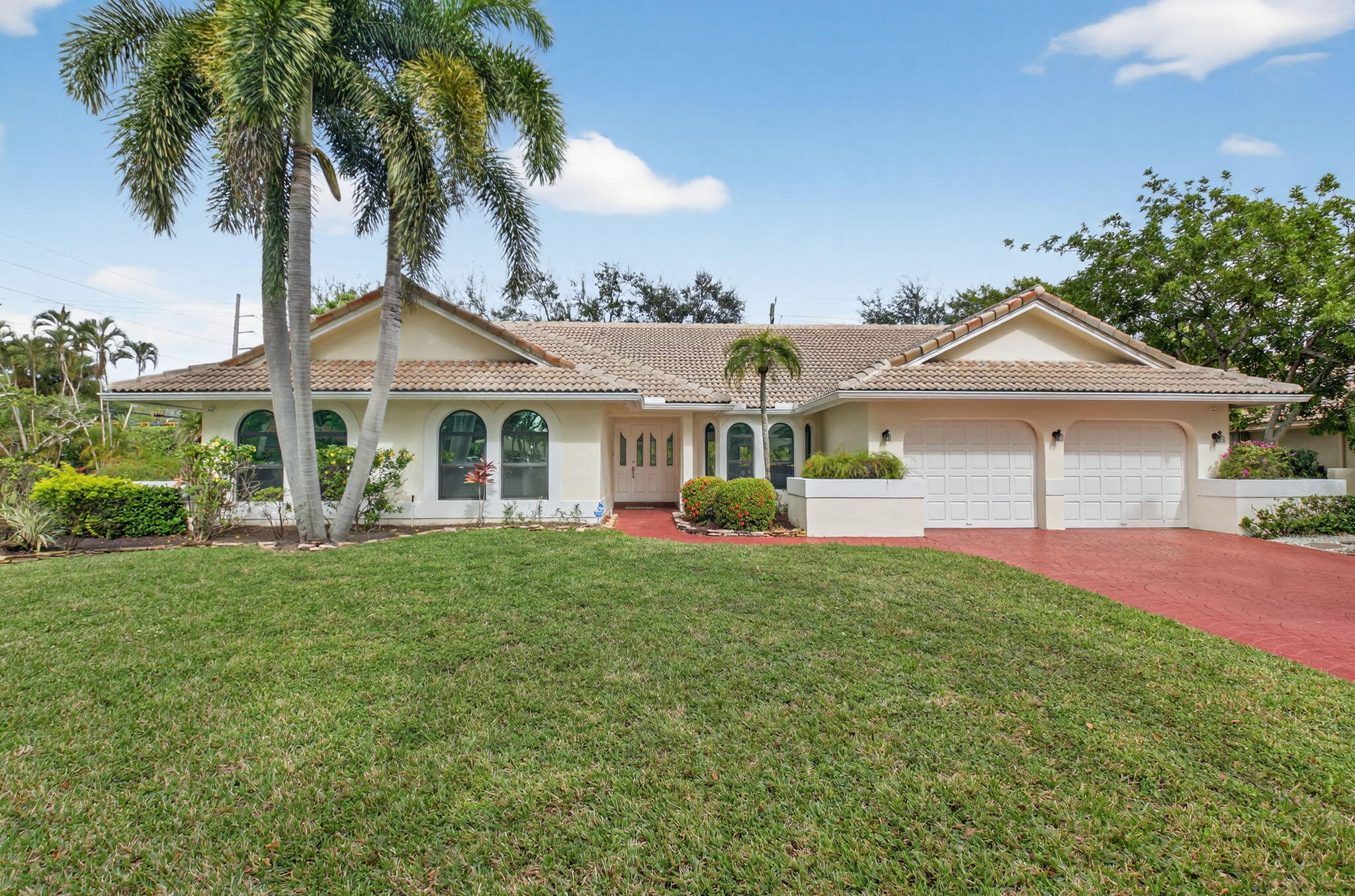 2871 Northwest 49th Street Boca Raton, FL 33434 - Photo 1 of 60 a front view of a house with a garden and porch