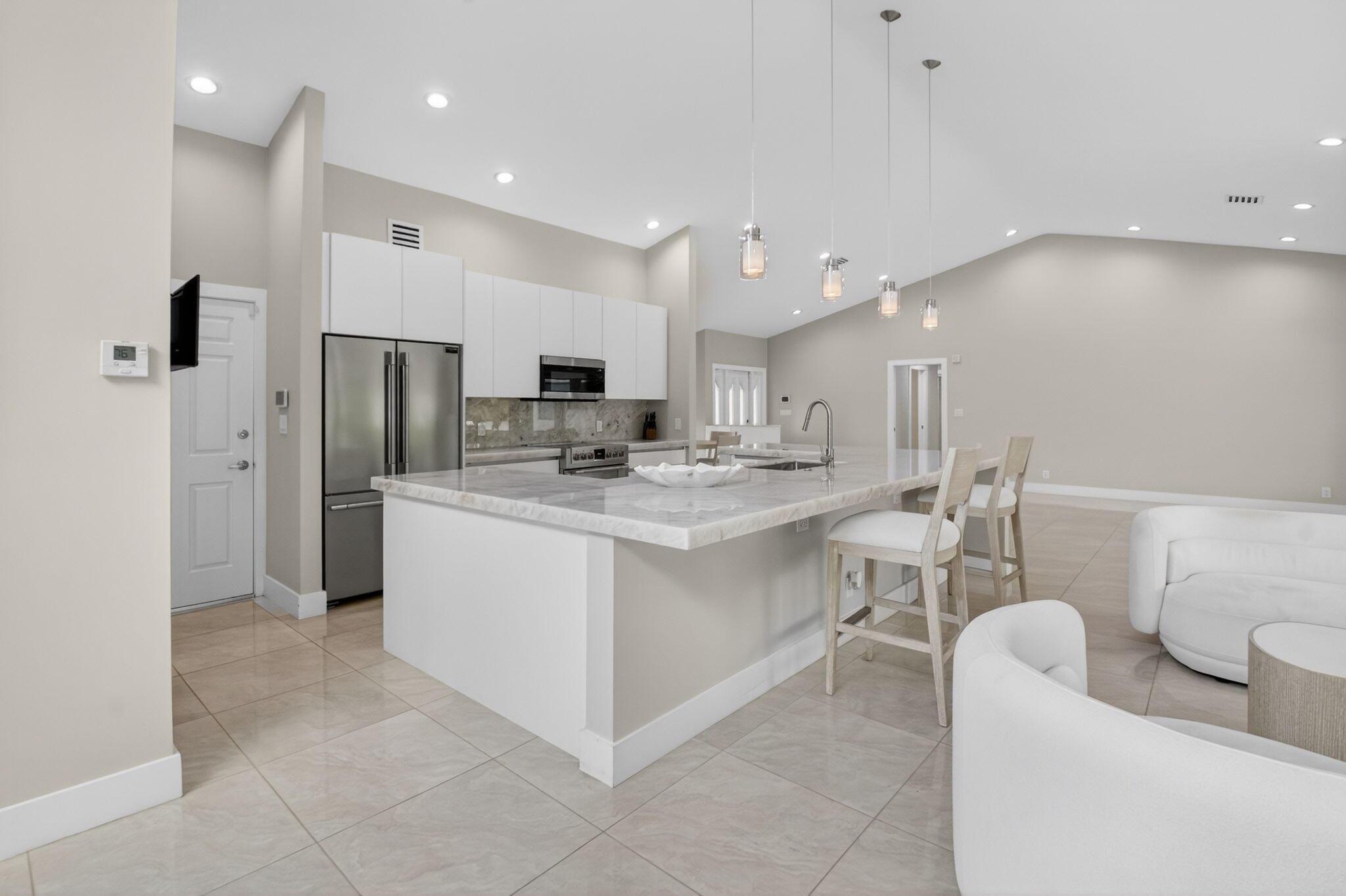 2871 Northwest 49th Street Boca Raton, FL 33434 - Photo 12 of 60 a kitchen with a refrigerator and a sink
