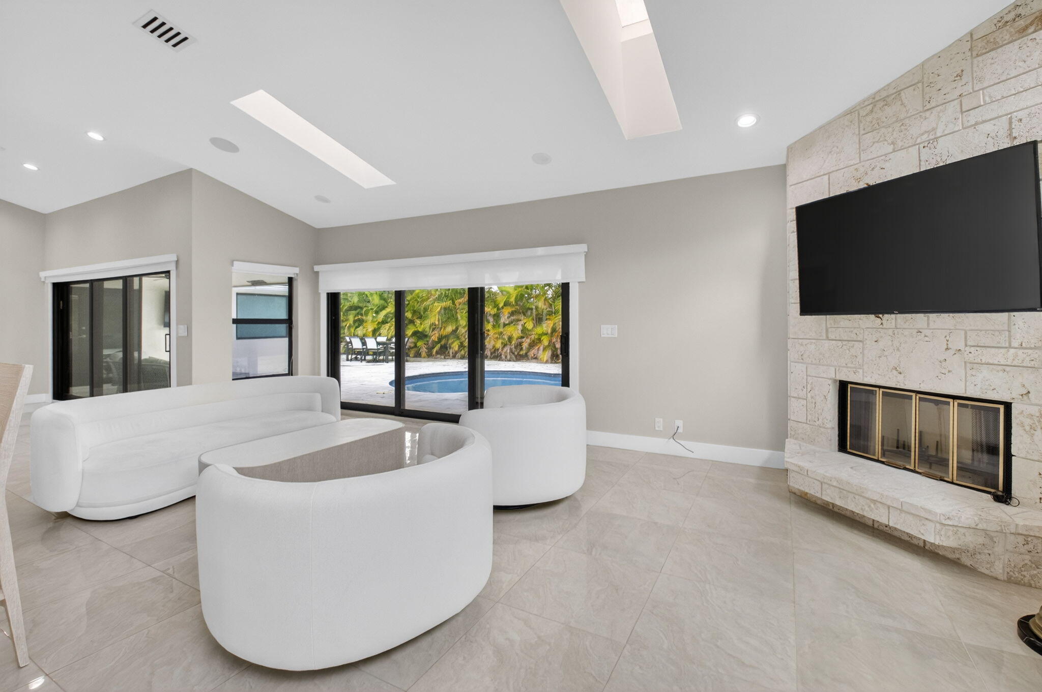 2871 Northwest 49th Street Boca Raton, FL 33434 - Photo 13 of 60 a living room with fireplace furniture and a flat screen tv