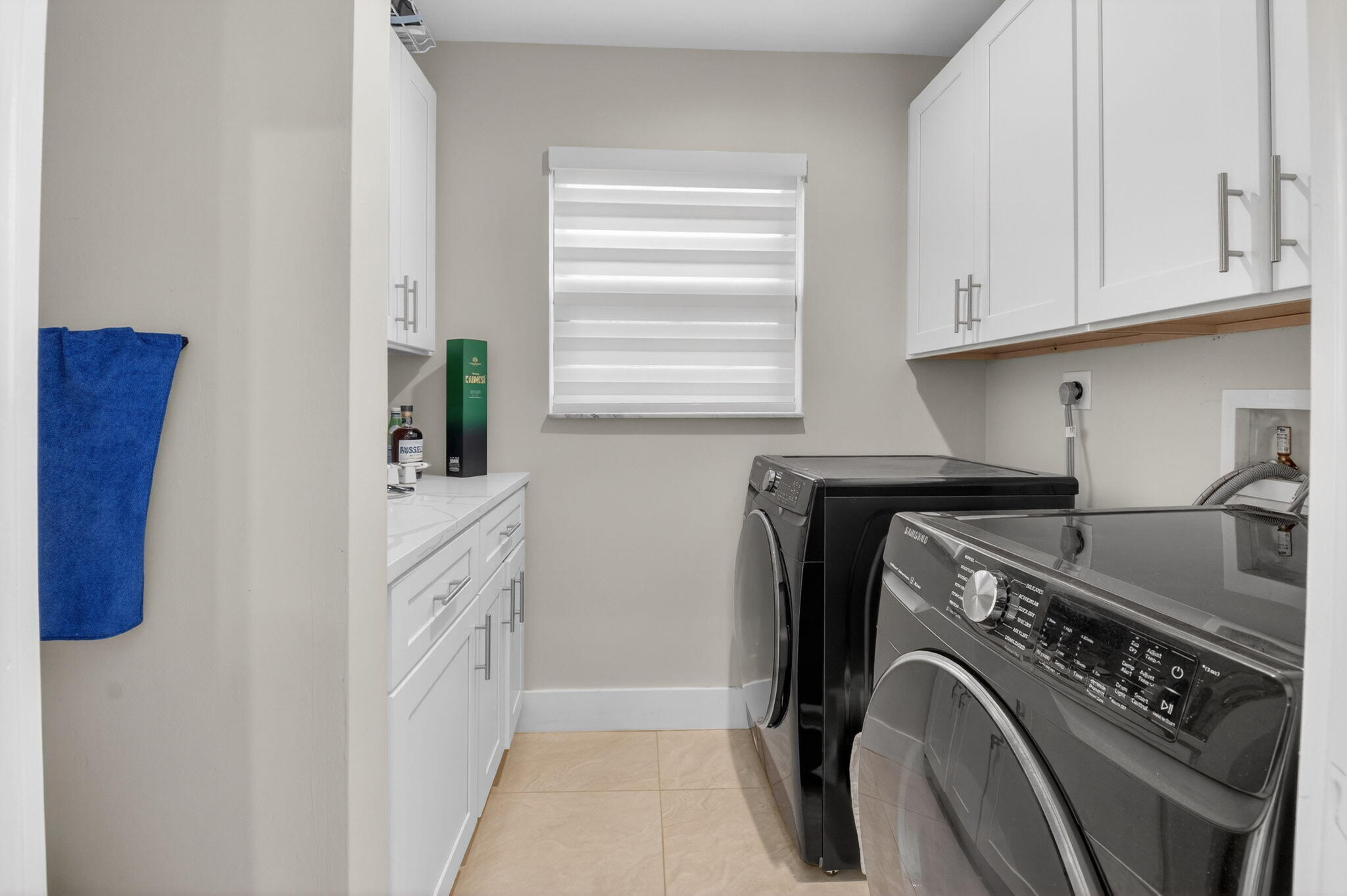 2871 Northwest 49th Street Boca Raton, FL 33434 - Photo 18 of 60 a utility room with cabinets washer and dryer
