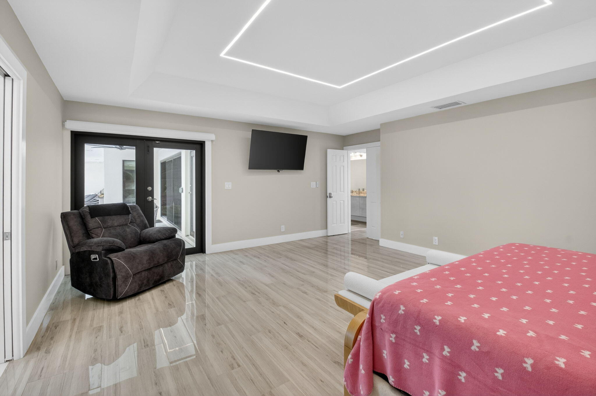 2871 Northwest 49th Street Boca Raton, FL 33434 - Photo 29 of 60 a living room with a bed furniture and a flat screen tv