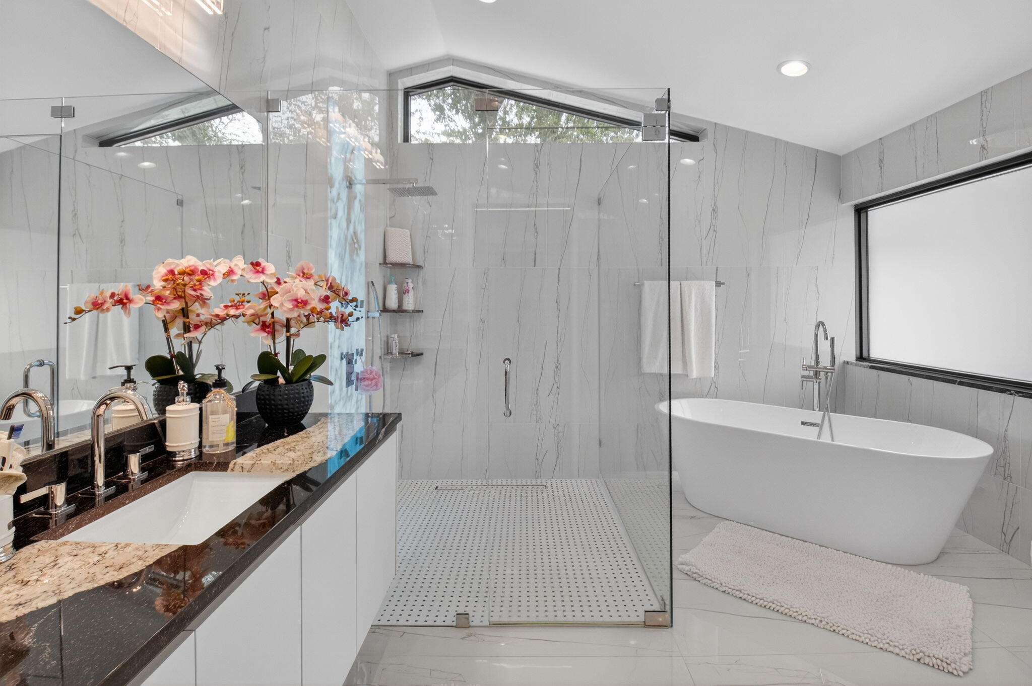 2871 Northwest 49th Street Boca Raton, FL 33434 - Photo 32 of 60 a bathroom with a tub sink mirror and a shower