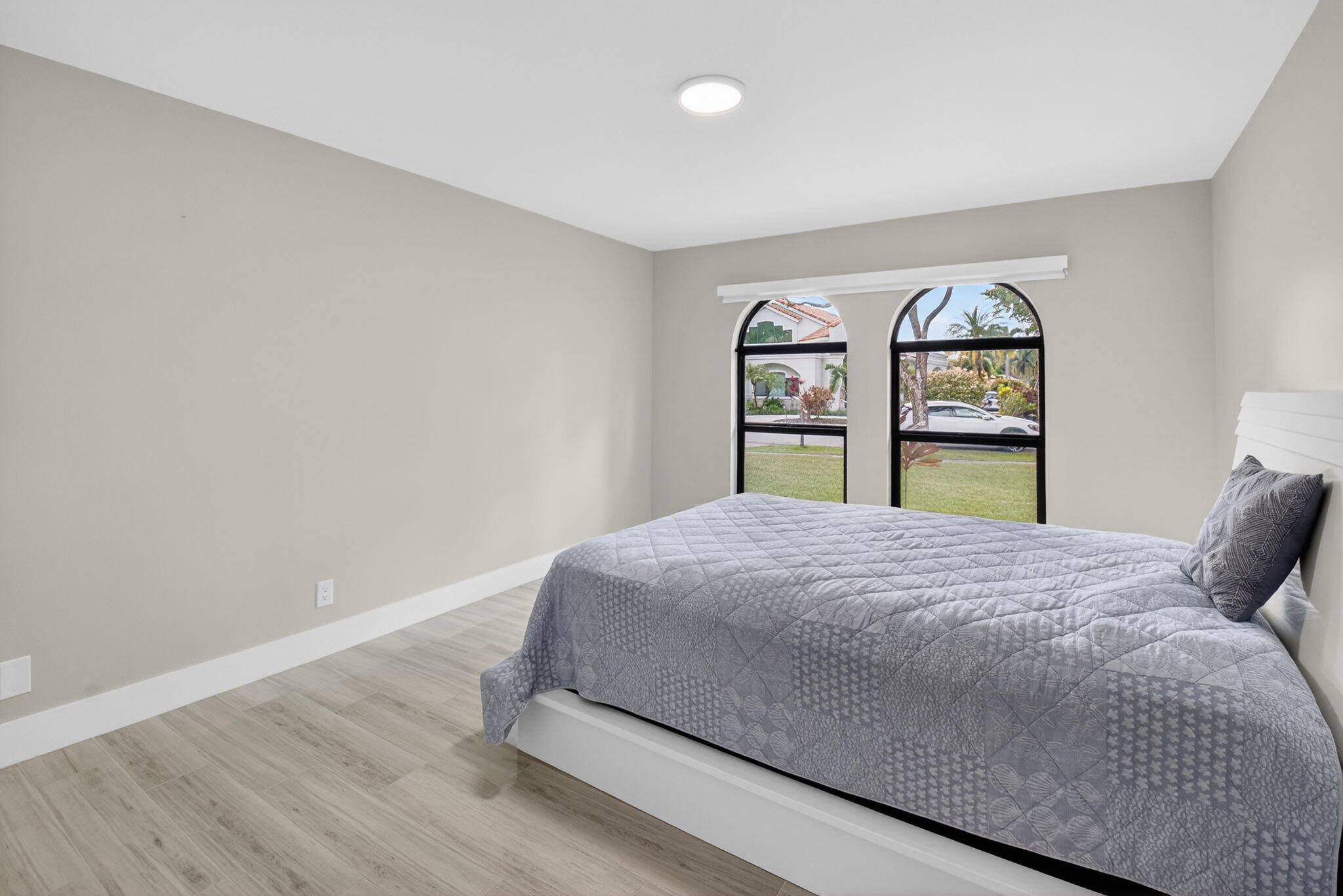 2871 Northwest 49th Street Boca Raton, FL 33434 - Photo 40 of 60 a bedroom with a bed and a large window