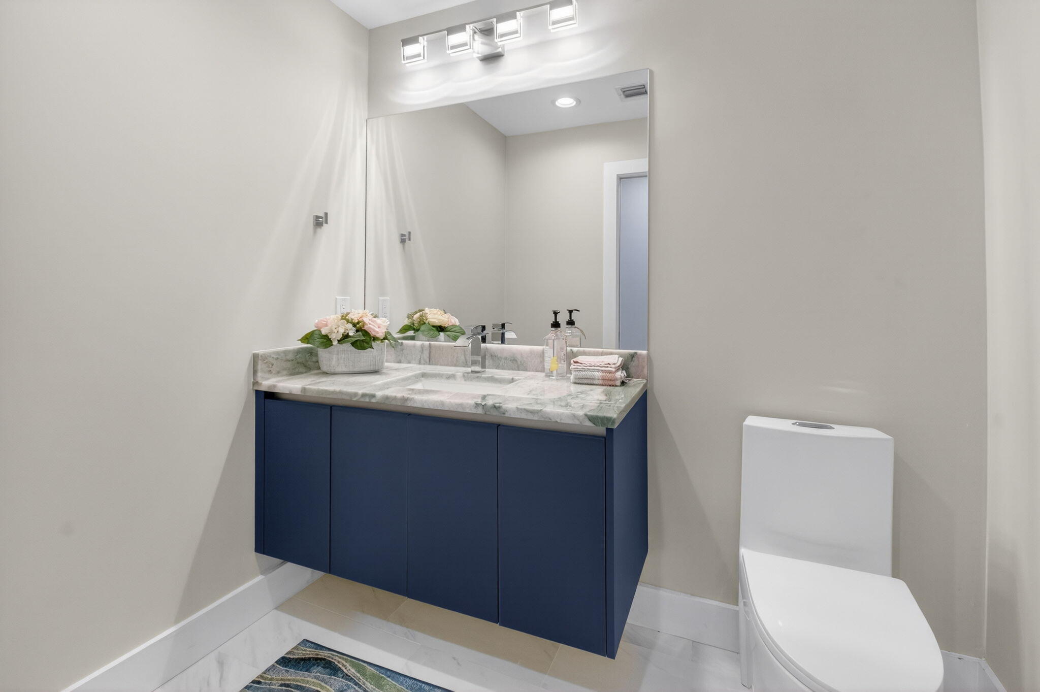 2871 Northwest 49th Street Boca Raton, FL 33434 - Photo 41 of 60 a bathroom with a sink vanity and toilet