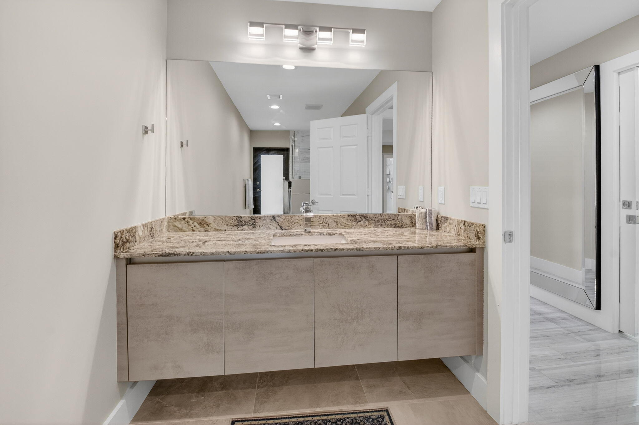2871 Northwest 49th Street Boca Raton, FL 33434 - Photo 42 of 60 a bathroom with a granite countertop sink and a mirror