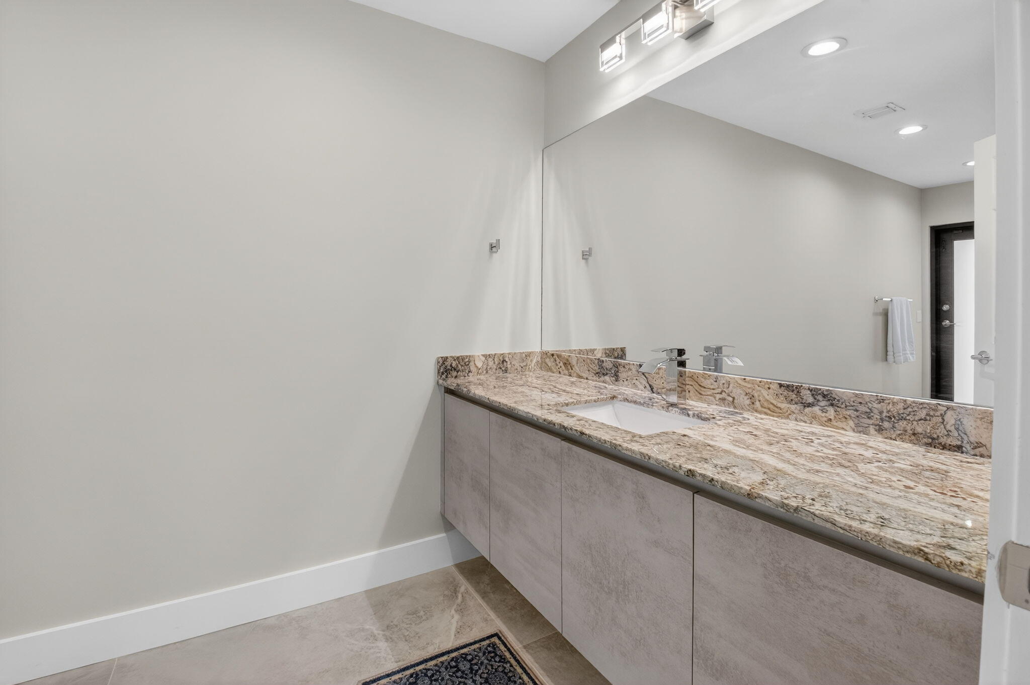 2871 Northwest 49th Street Boca Raton, FL 33434 - Photo 43 of 60 a bathroom with a granite countertop sink and a mirror
