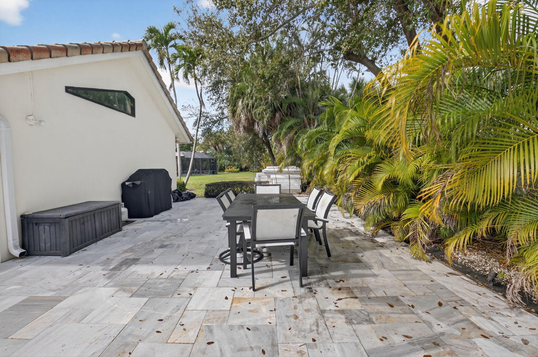 2871 Northwest 49th Street Boca Raton, FL 33434 - Photo 49 of 60 a view of a chairs and table in backyard