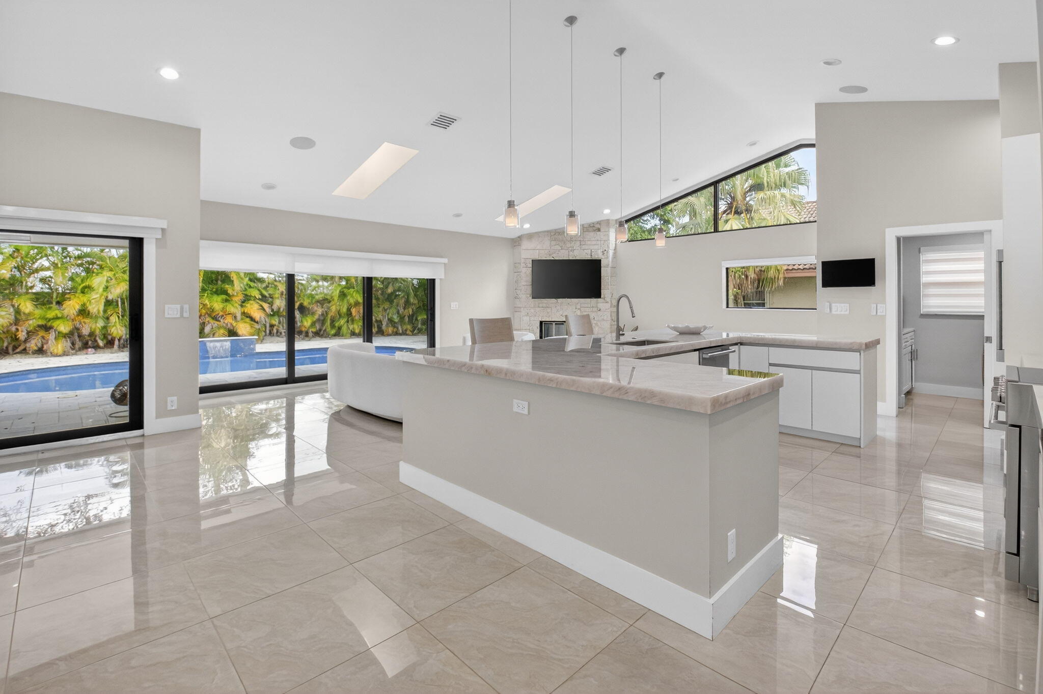 2871 Northwest 49th Street Boca Raton, FL 33434 - Photo 5 of 60 a large white kitchen with a large window and stainless steel appliances