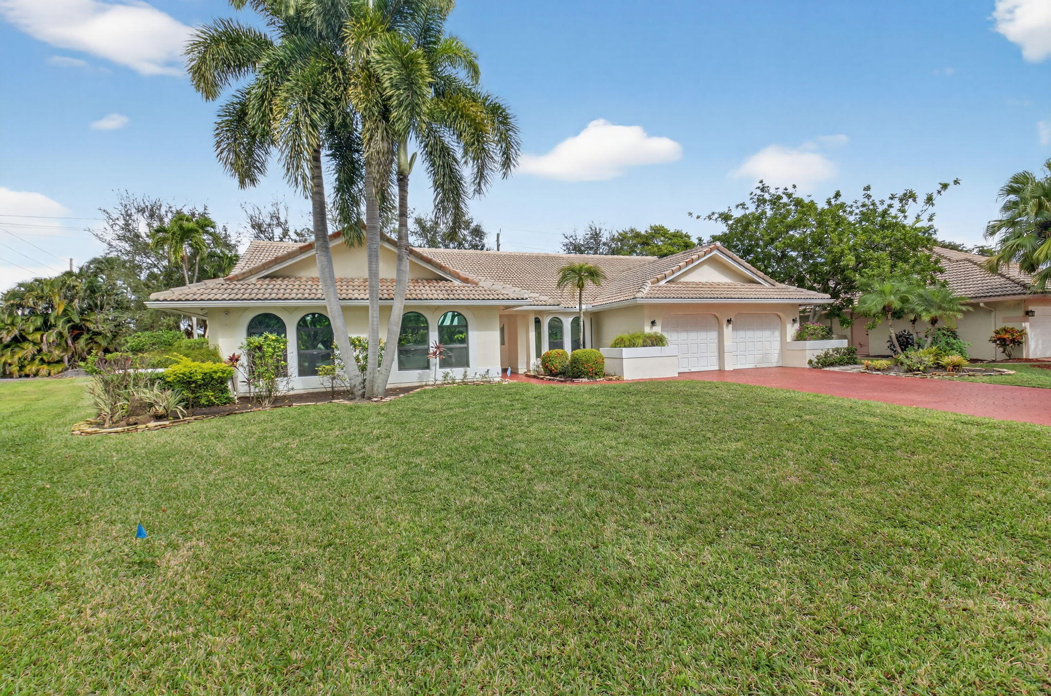 2871 Northwest 49th Street Boca Raton, FL 33434 - Photo 54 of 60 a front view of a house with a garden