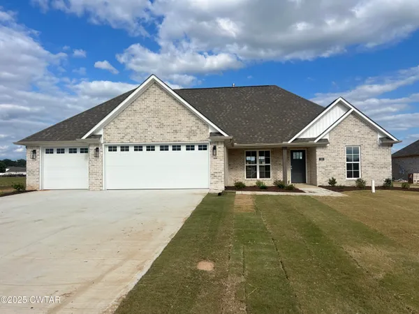 a view of a house with a yard and garage