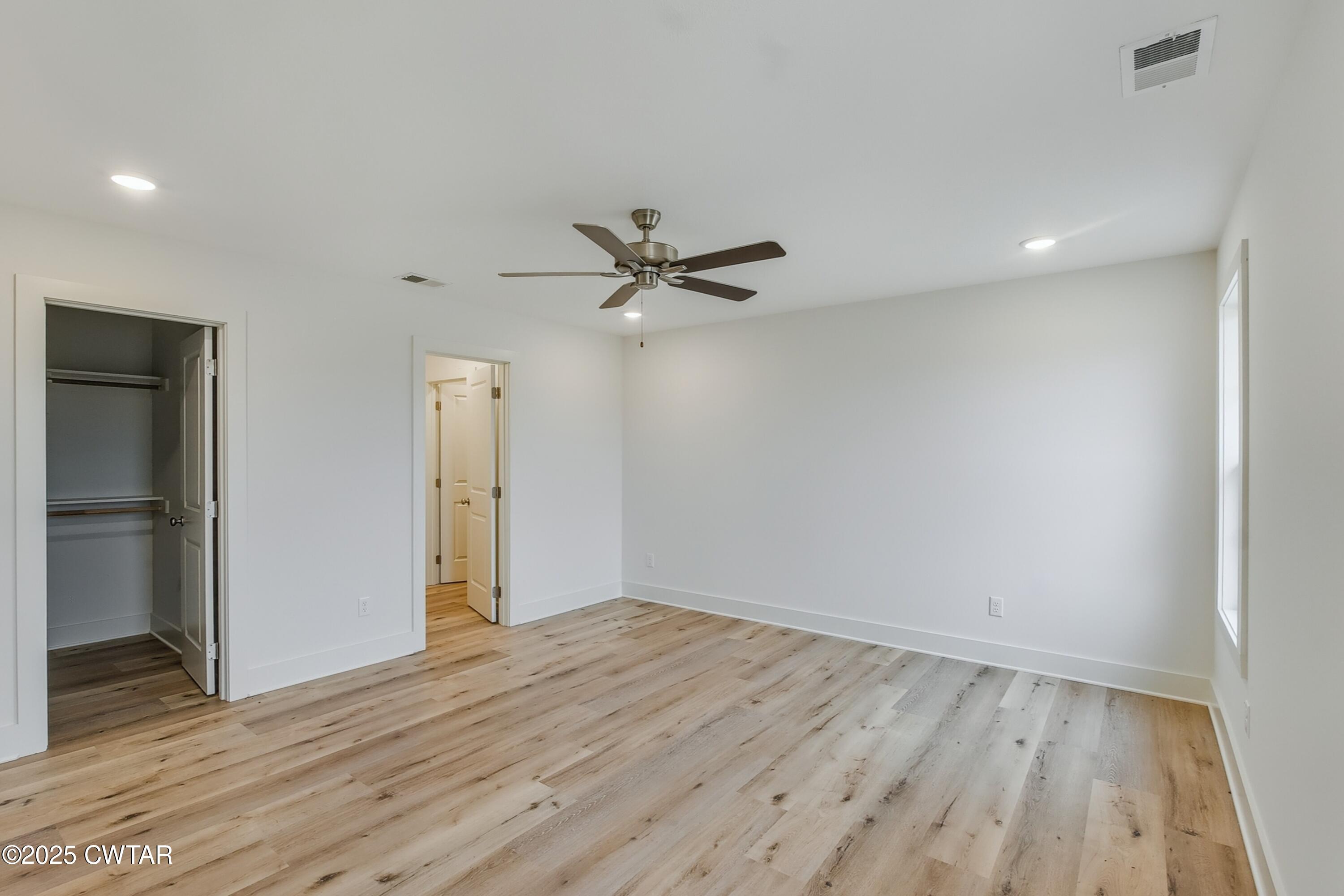 110 Daybreak Loop Medina, TN 38355 - Photo 12 of 21 an empty room with wooden floor and a ceiling fan