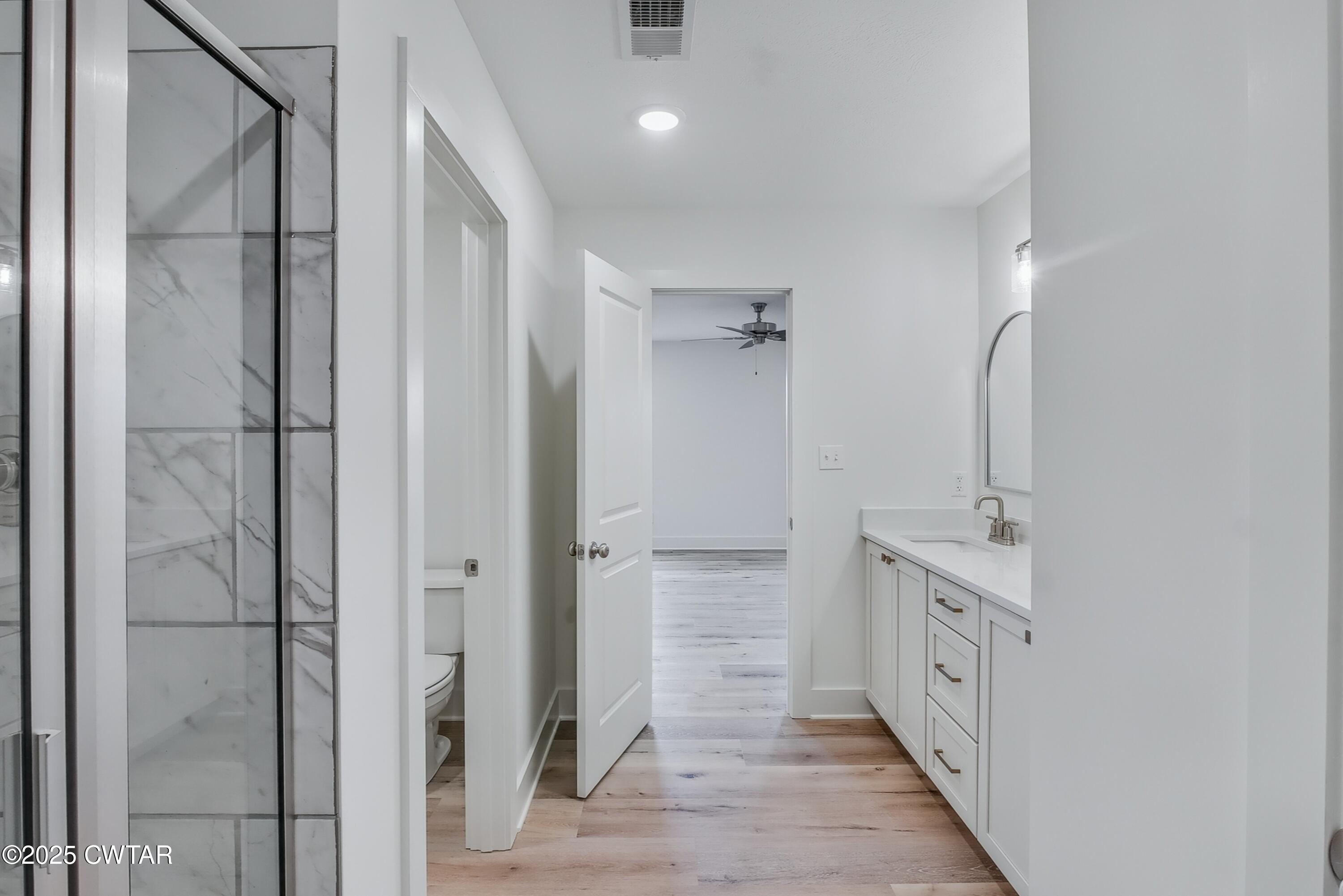 110 Daybreak Loop Medina, TN 38355 - Photo 13 of 21 a bathroom with a double vanity sink a mirror and a shower